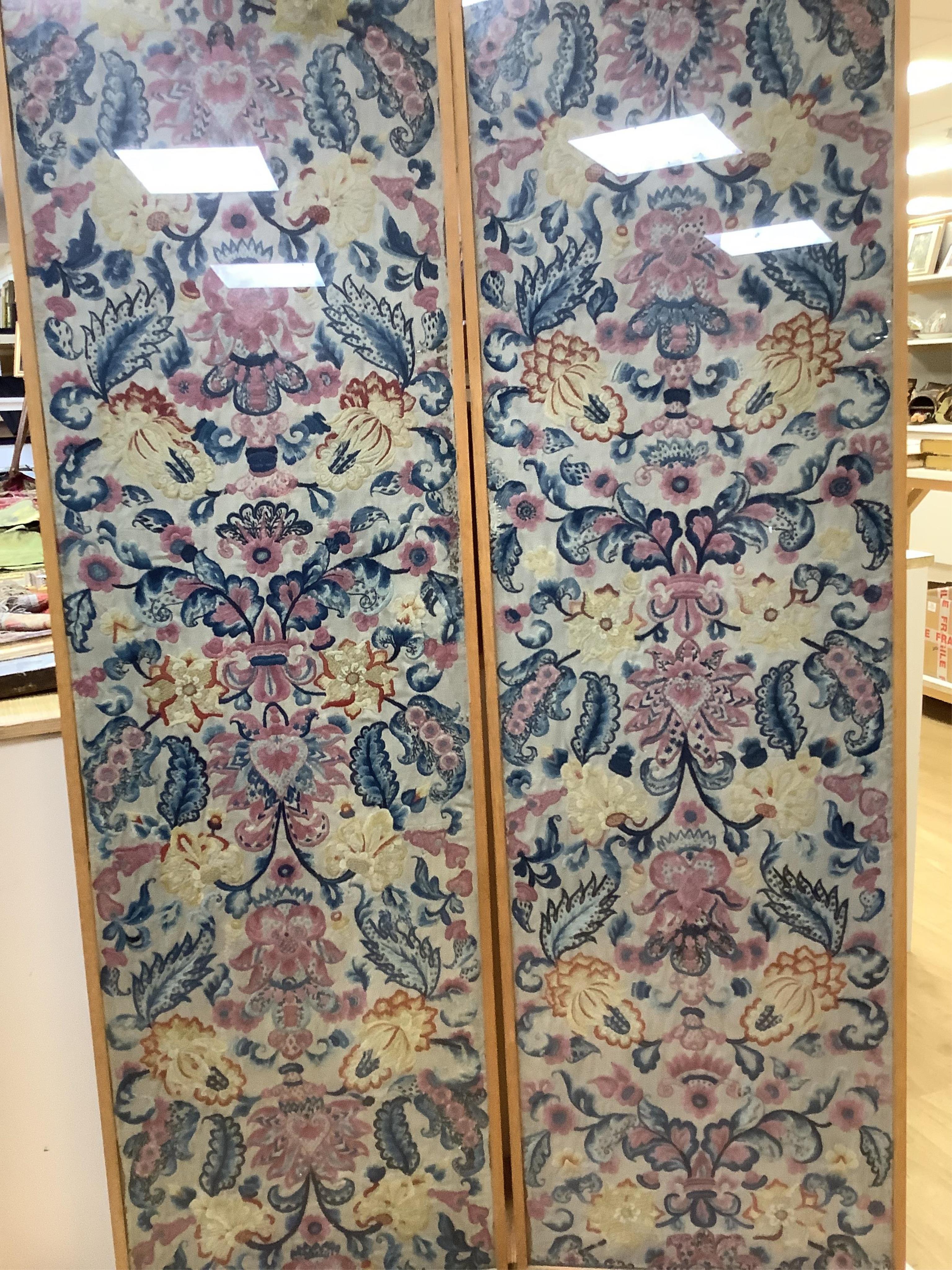 Two unusual 19th- 20th century French crewel worked panels. Embroidered predominantly in shades of blue, pink, yellow and orange, onto a light grey cloth, using neoclassical and rococo design elements. Possibly part of a